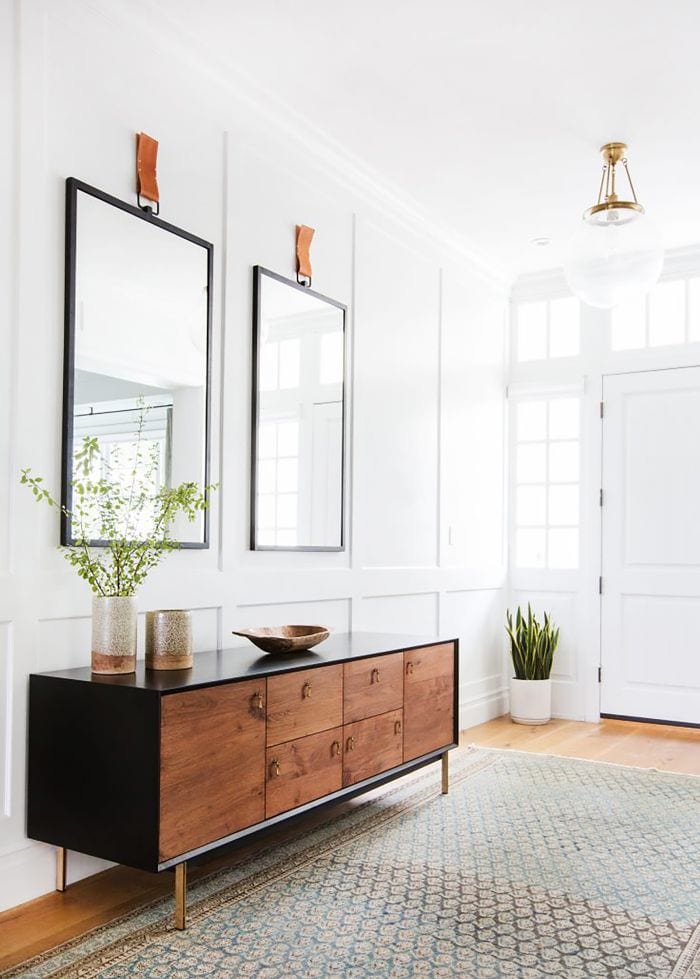entryway with two mirrors and credenza
