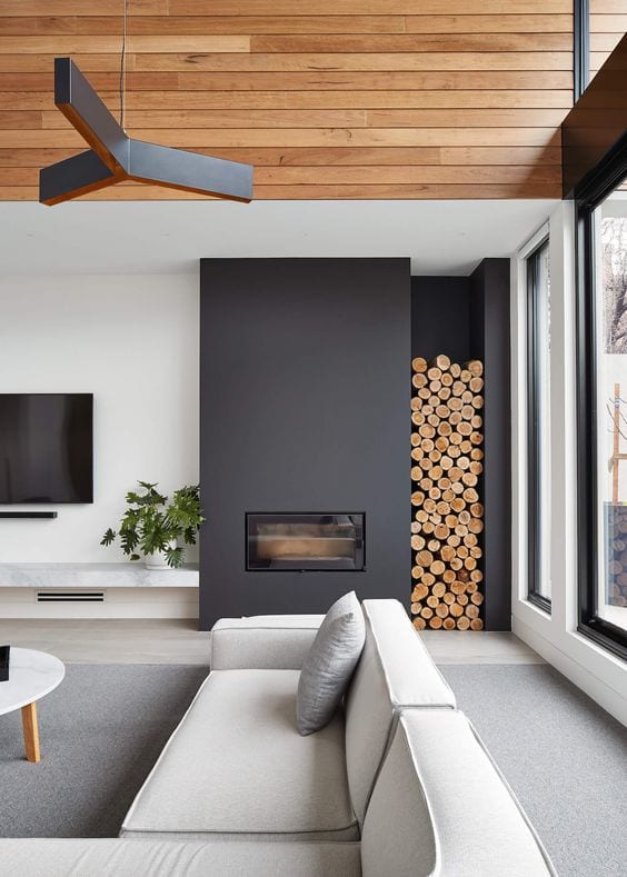 modern asymmetrical fireplace with wood stack