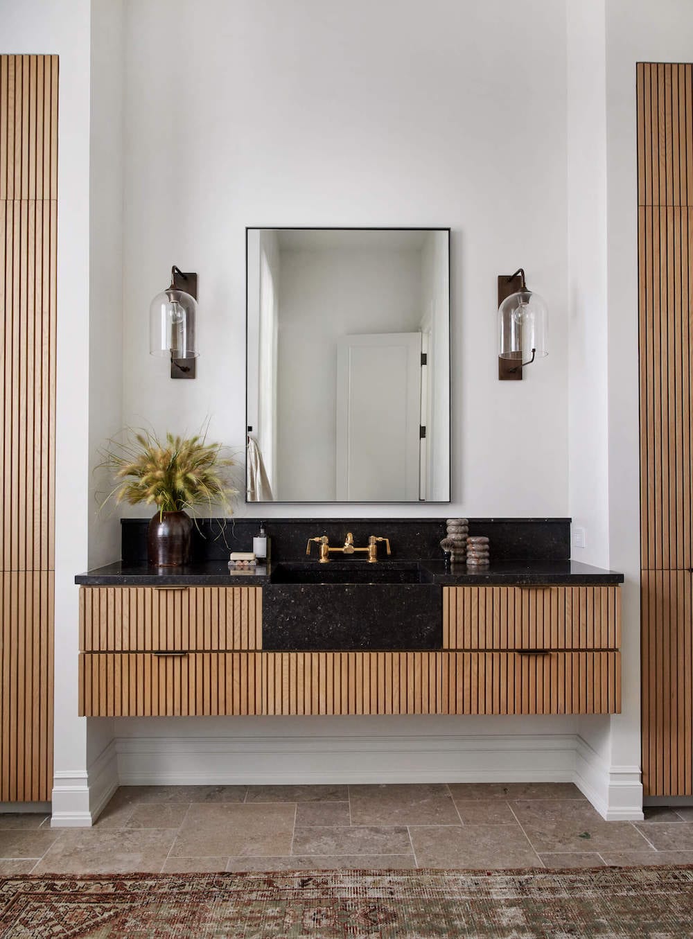 slatted floating vanity with black stone