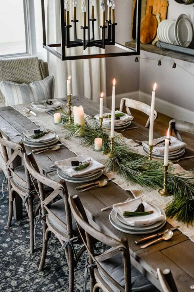 simple holiday tablescape with greenery down middle