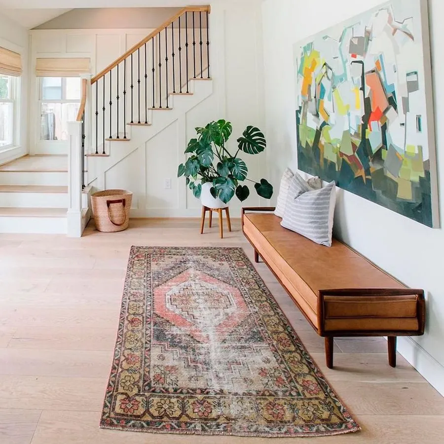 entryway with bench and art