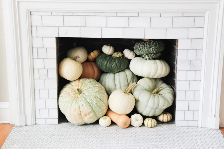 pumpkins stacked in fireplace