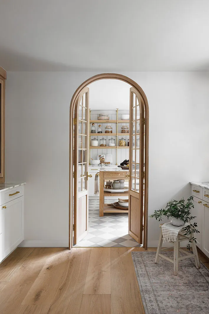 wood framed doorway to butler kitchen with floating wood shelves