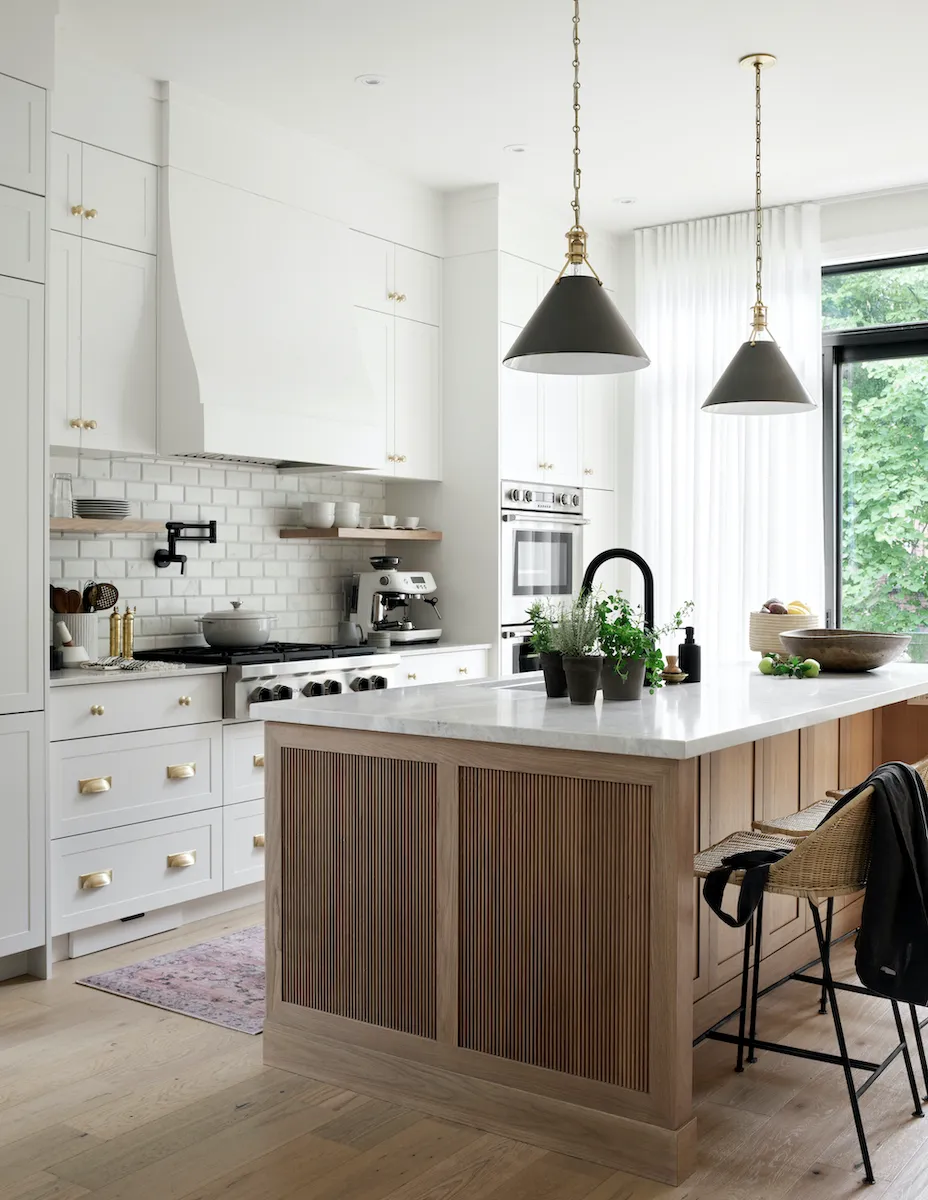 oversized wood kitchen island and white cabinetry